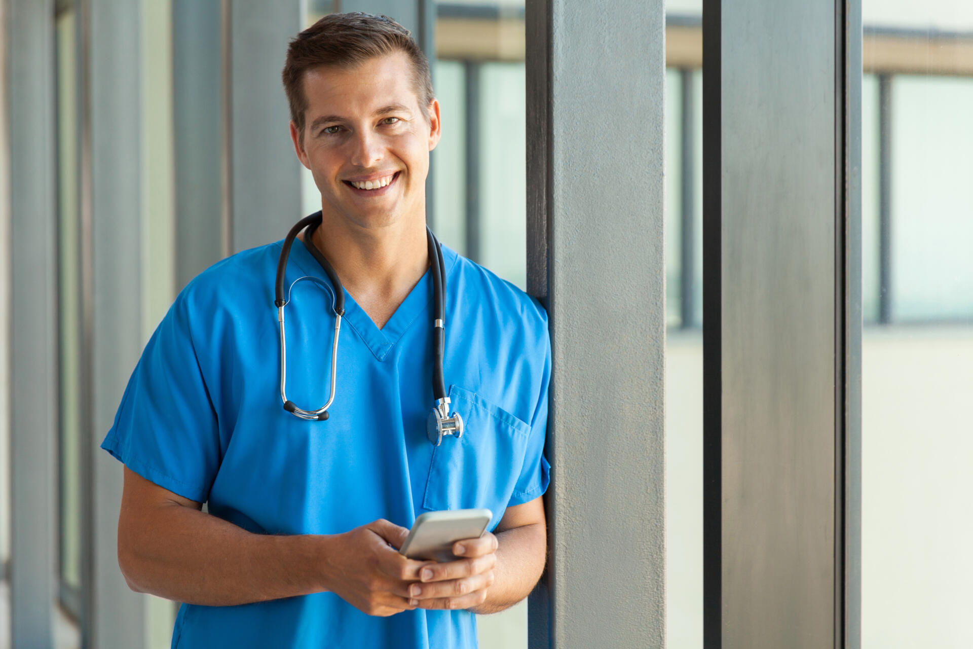young doctor holding cell phone