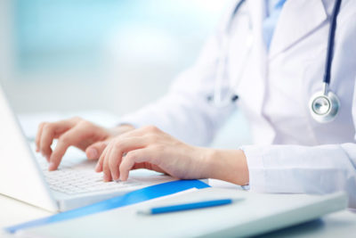 Medical professional typing