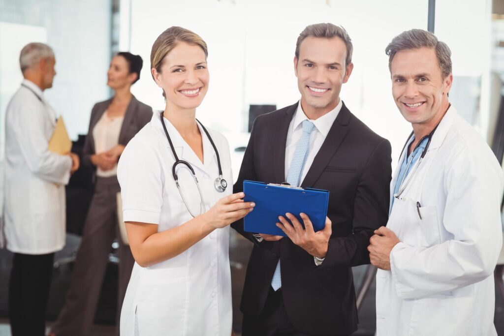 Portrait of happy medical team with clipboard