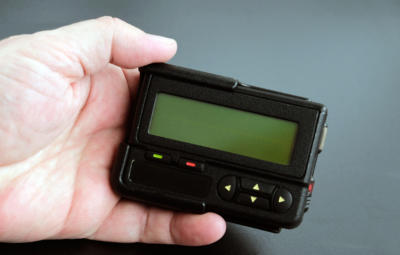 Old black pager in hand