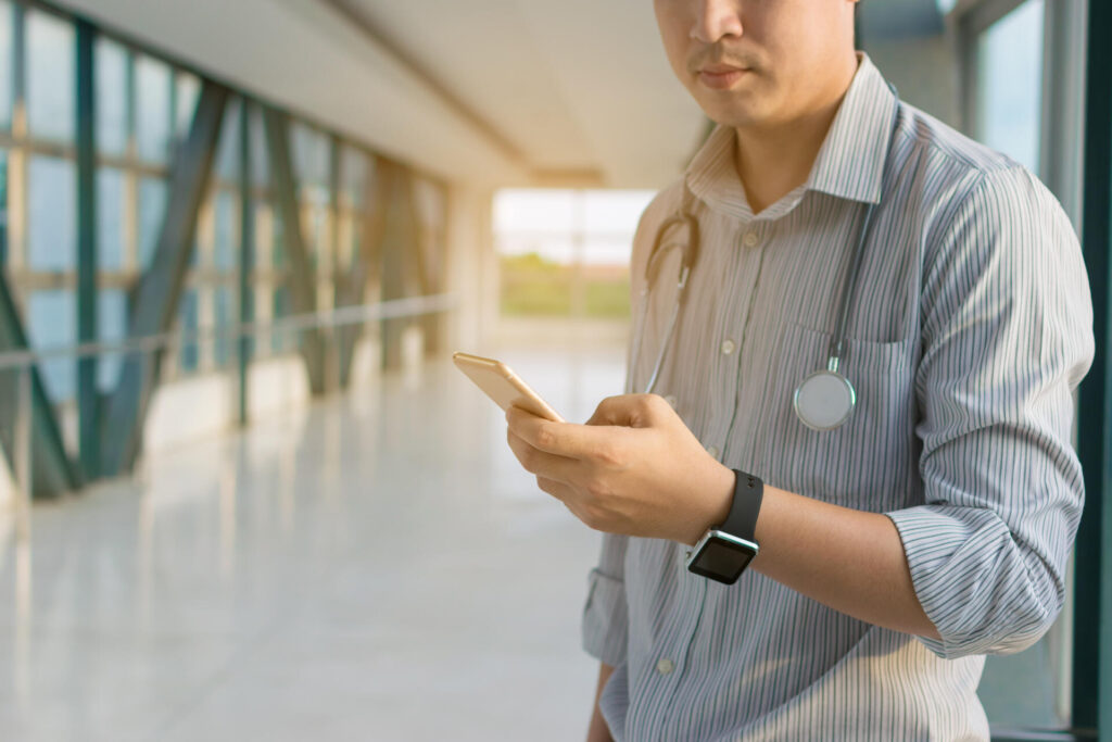 Doctor Capturing Charges on Smartphone in Hospital