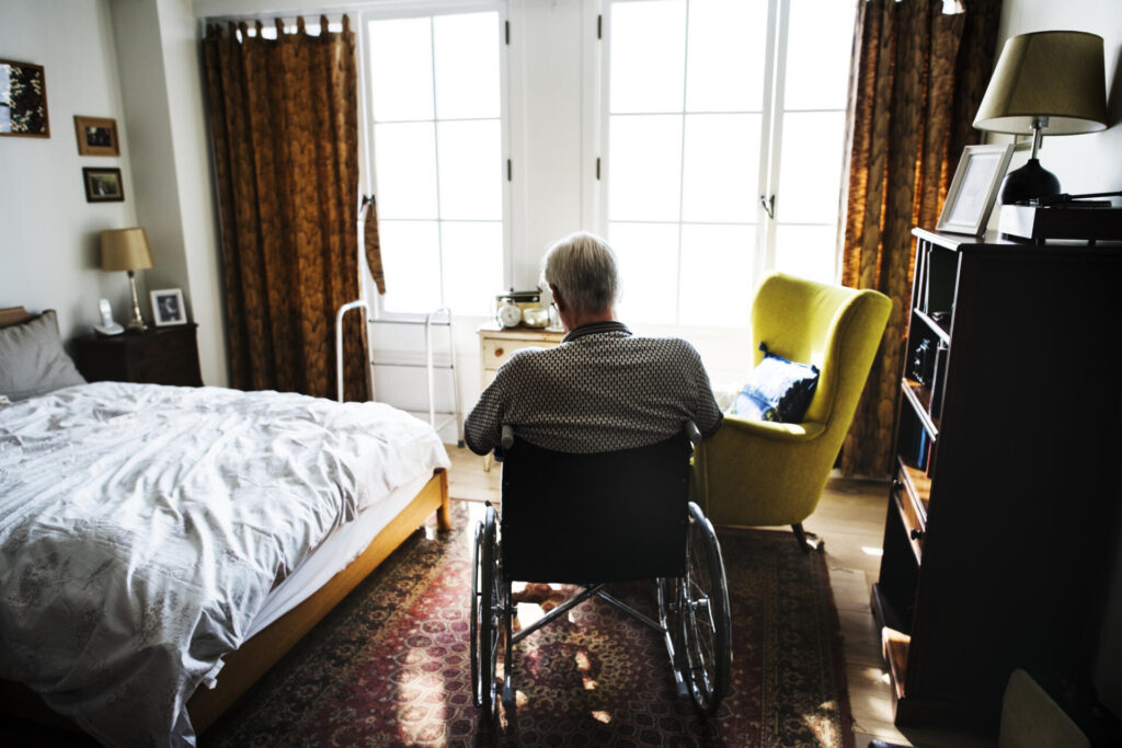 Senior man sitting on wheelchair alone