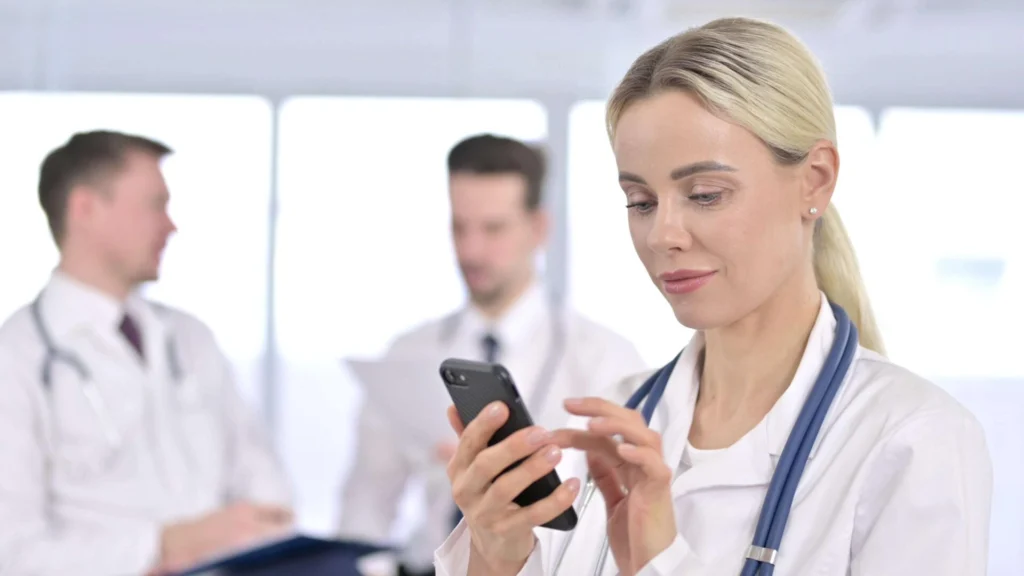 Female Doctor using Smartphone in Office