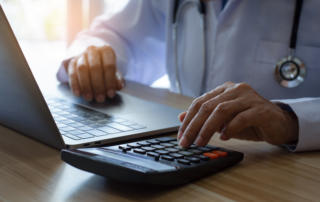 Doctor or physician using calculator